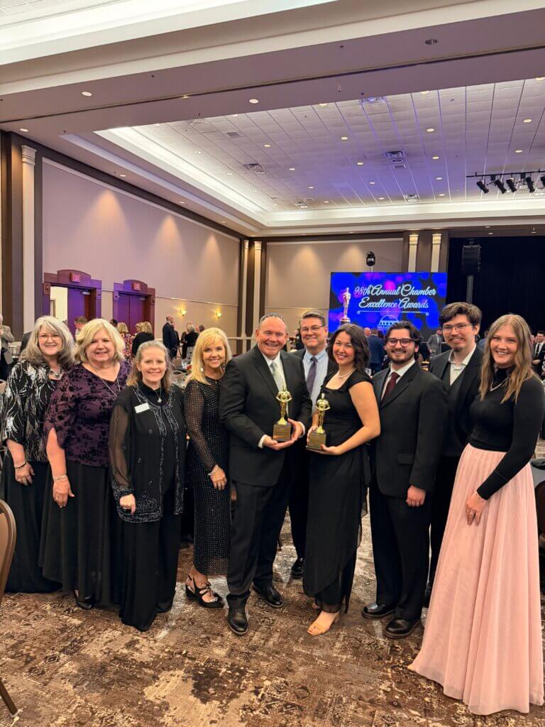 Friends and family posing with awards.