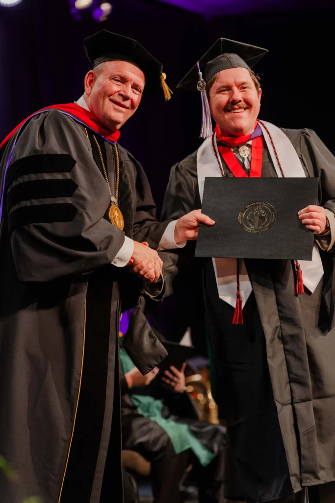 President Bridges presenting diploma