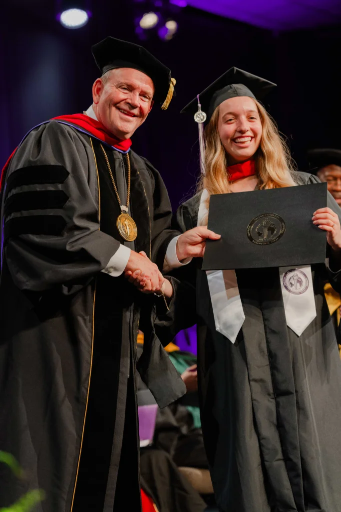 President Bridges presenting diploma