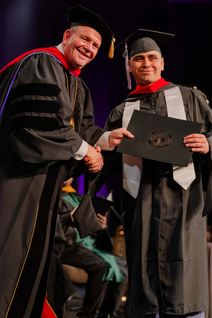 President Bridges presenting diploma