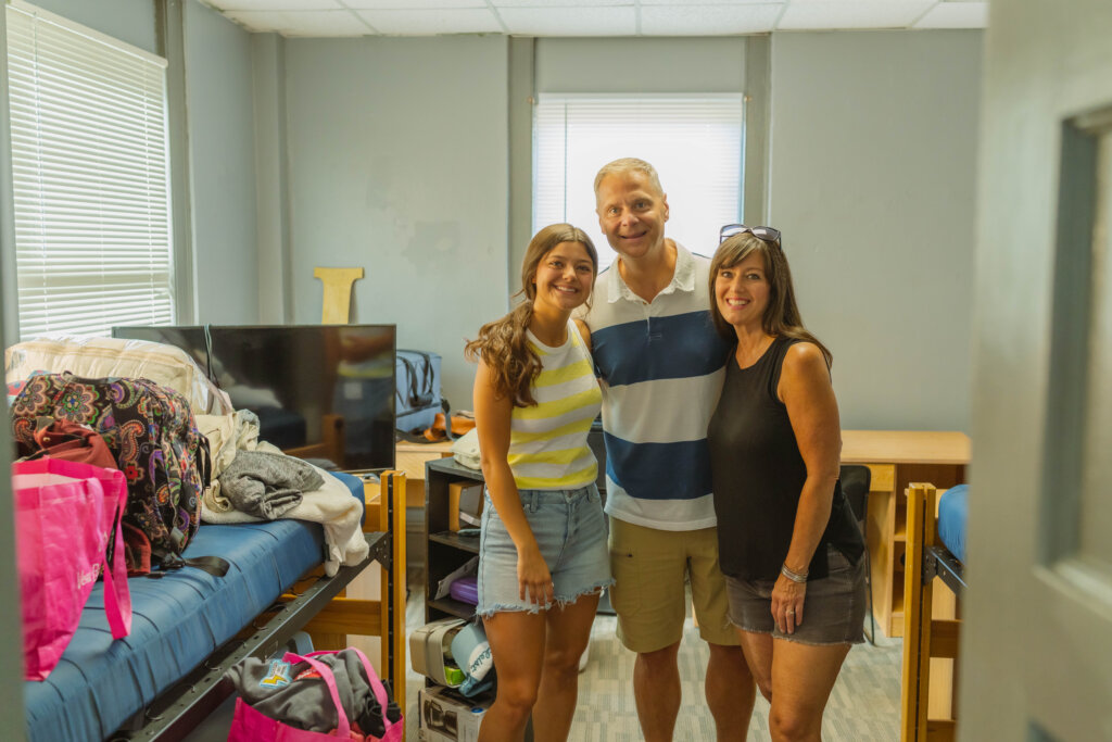 student with parents in dorm