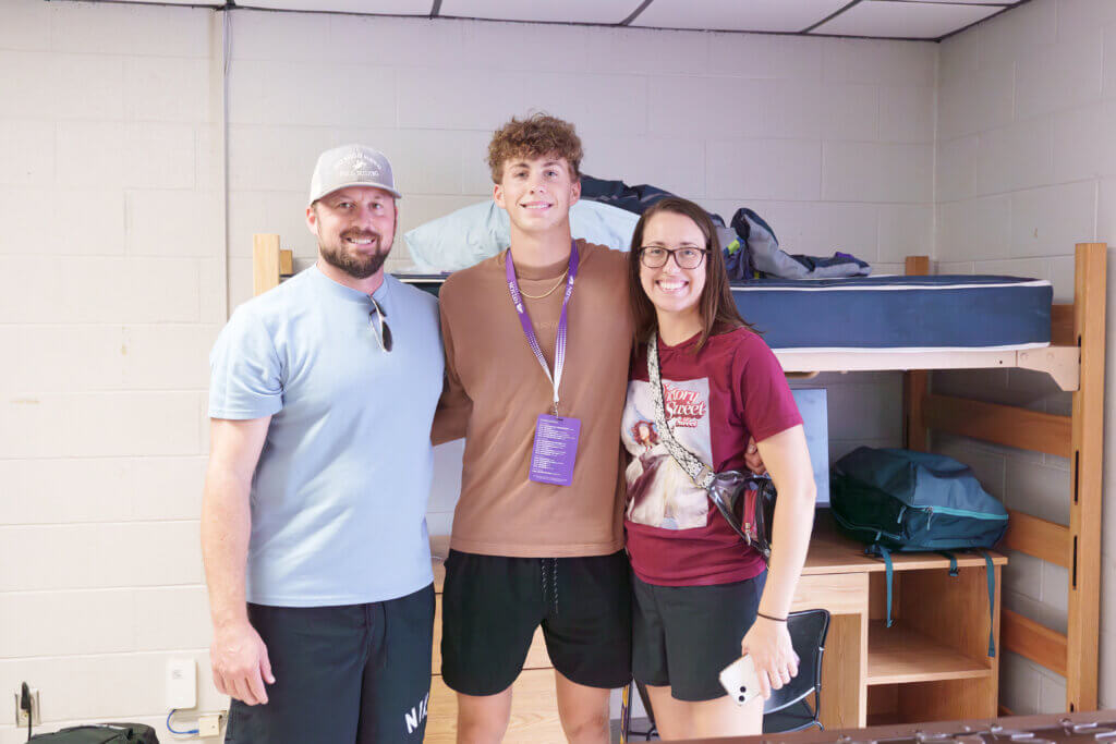 student with parents in dorm