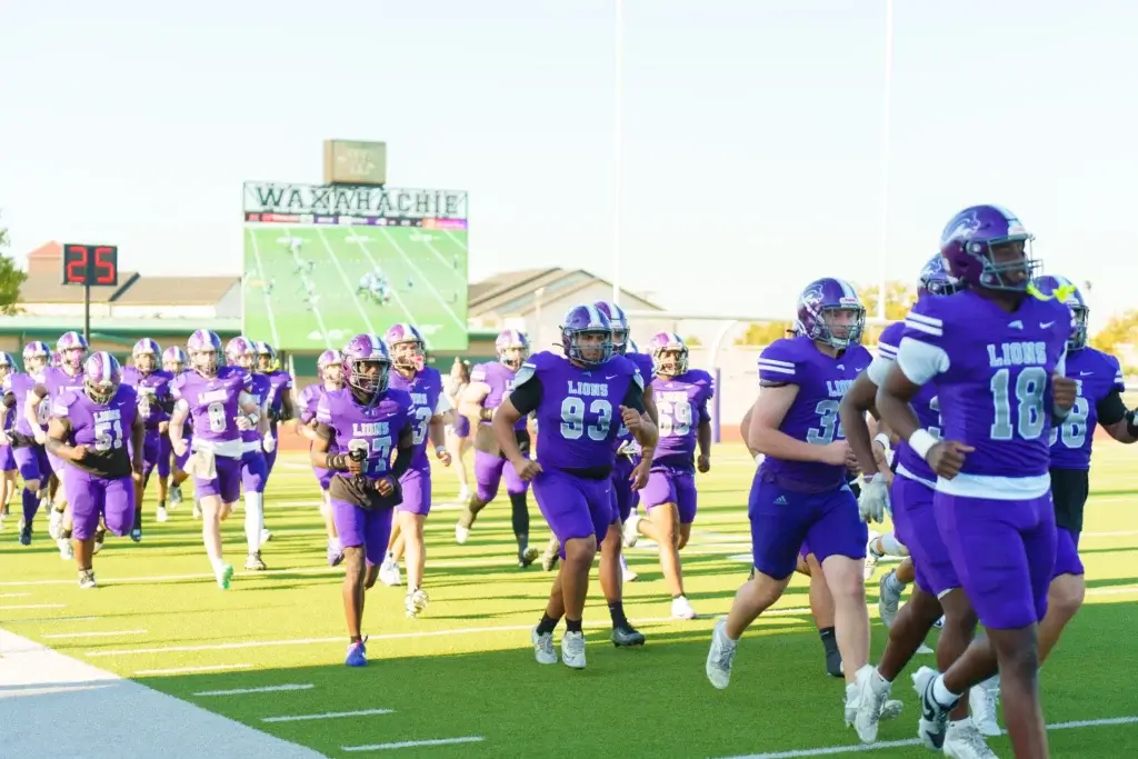 Campus-life 17 football players running onto the field