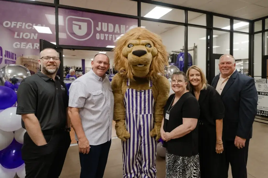 people posing with Judah the lion