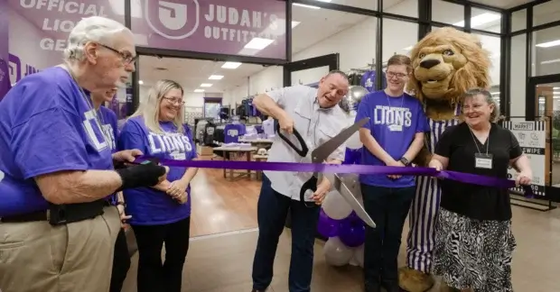 President Bridges cutting the ribbon in front of Judah's Outfitters
