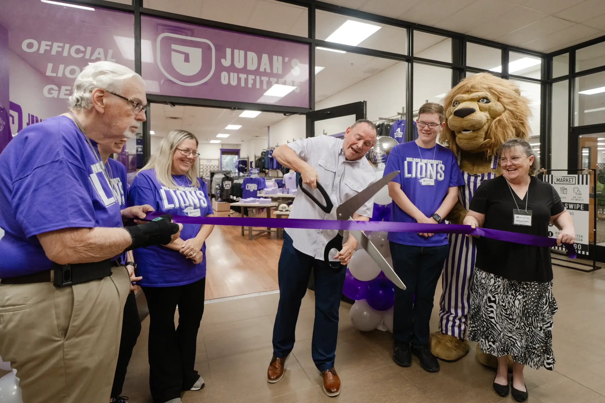 President Bridges cutting the ribbon in front of Judah's Outfitters